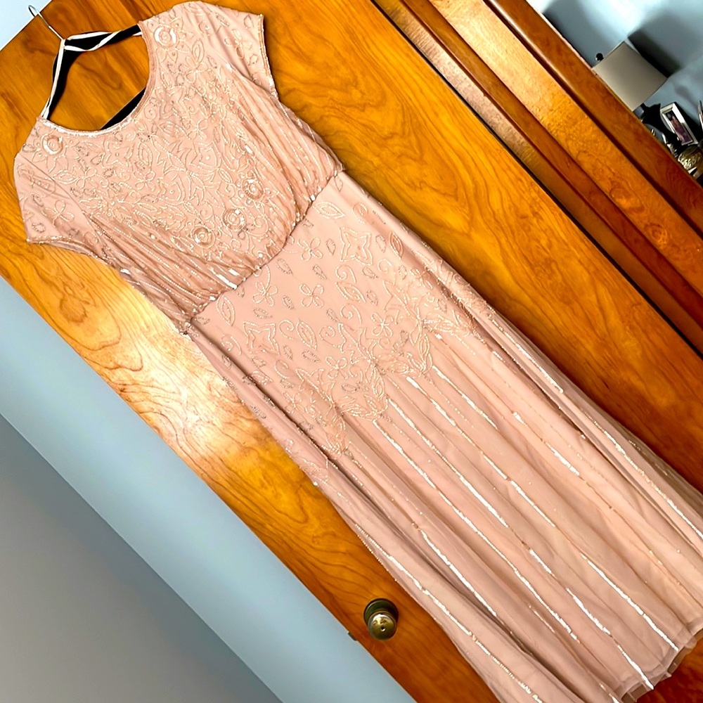 Beautifully beaded and sequined dress.  Worn once. Like new condition.  Size 12.